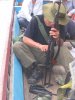 knla soldier taking care of his AK.jpg